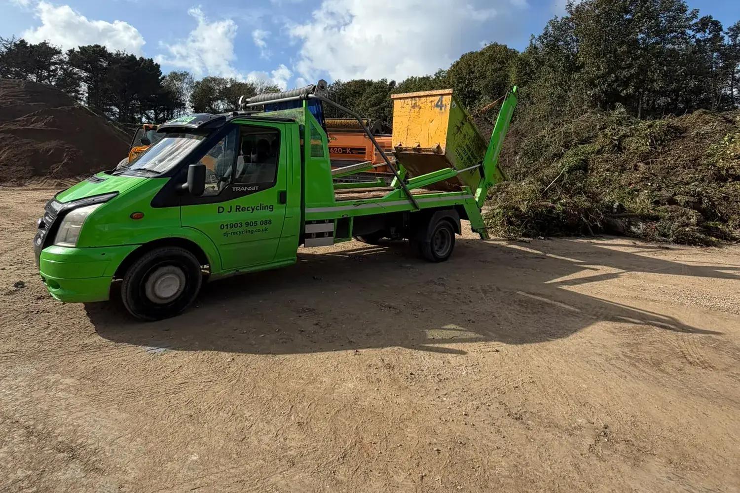 DJ Recycling lorry tipping a 4-yard skip of green waste