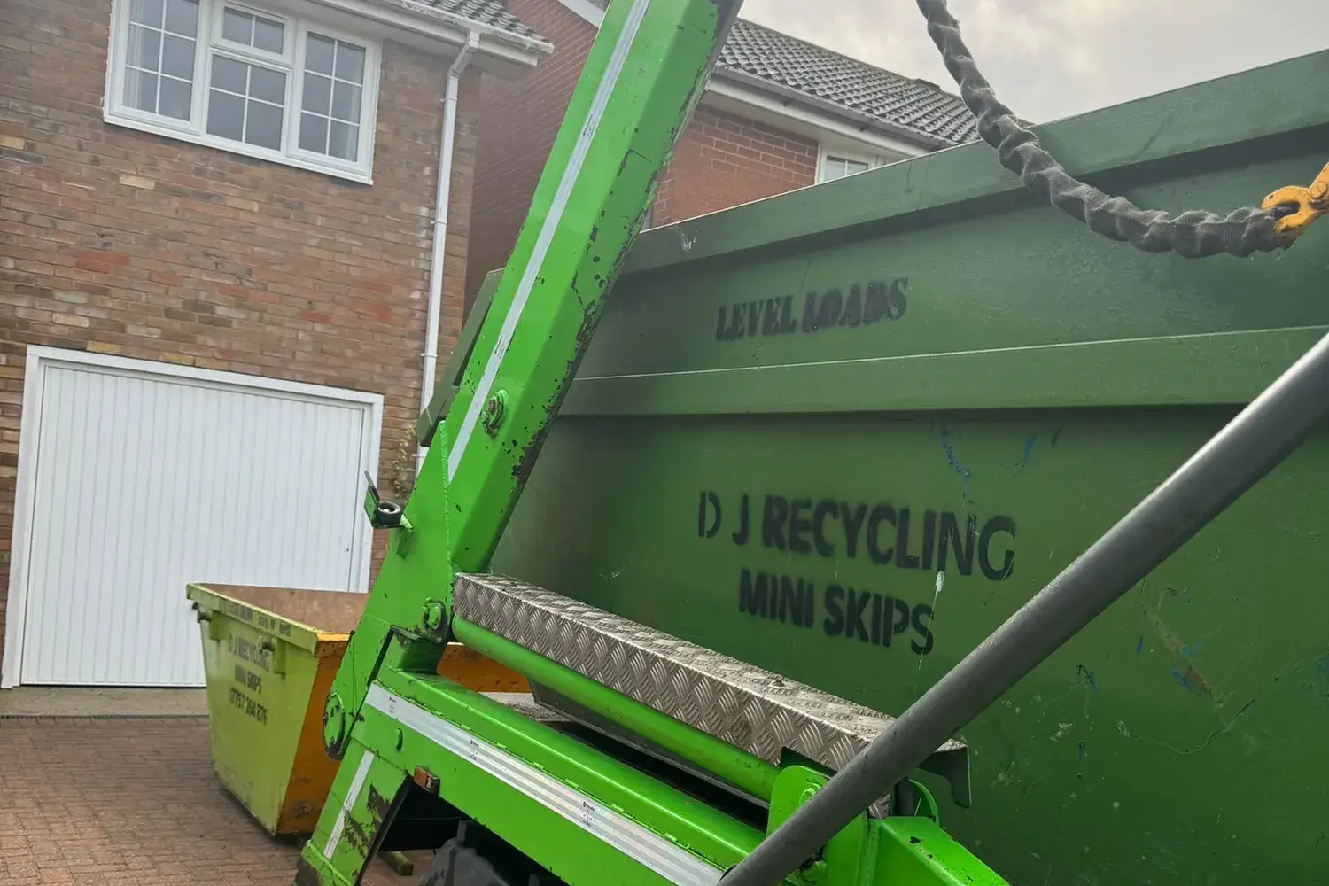 Skip delivered onto a block-paved driveway by DJ Recycling
