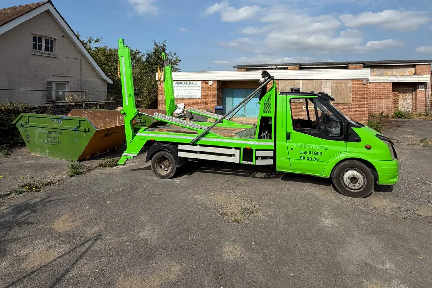 DJ Recycling lorry beside an 8-yard skip at a commercial site