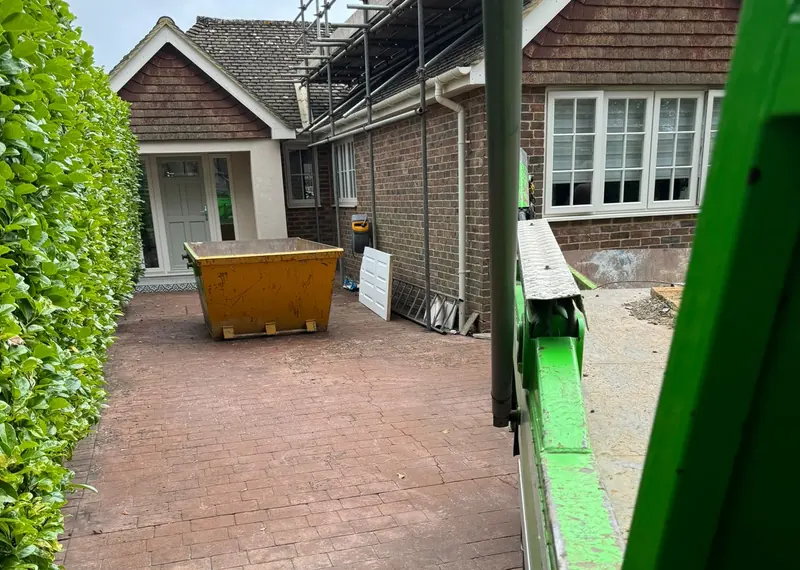 Skip on a paved driveway at a residential property
