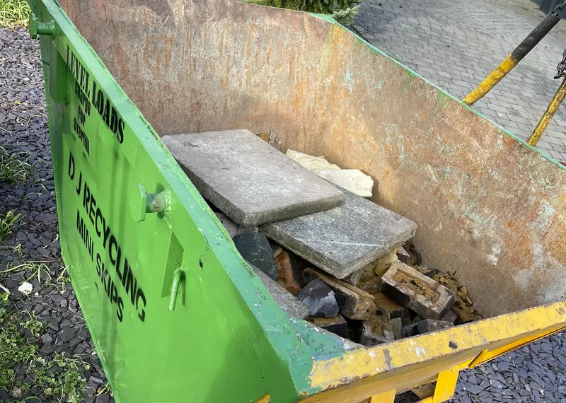 DJ Recycling skip containing building rubble